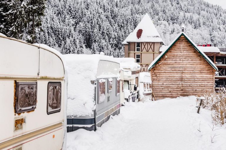 Travel trailers and campers outside in snow during the winter