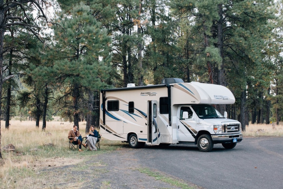 Couple with RV rental camping outdoors