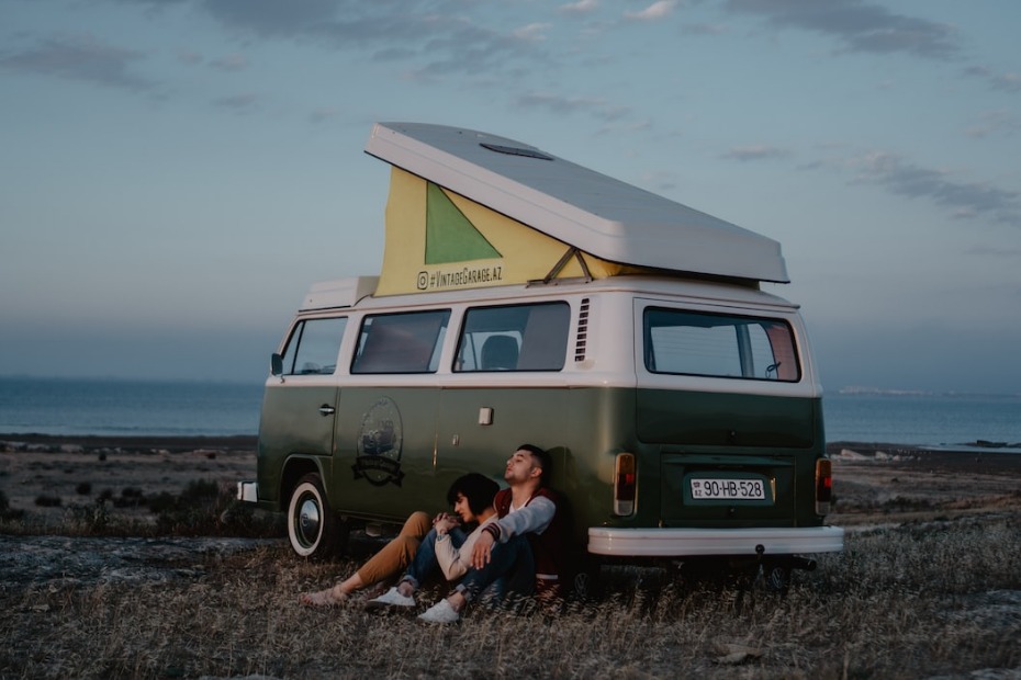 couple next to rV in field