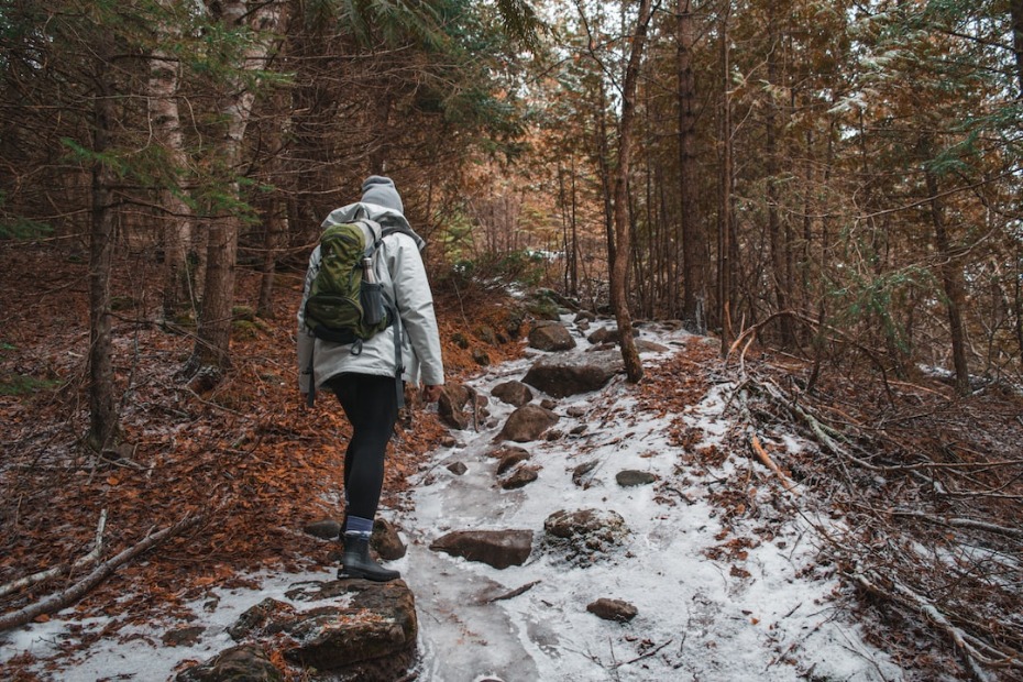 man hiking during winter on trail