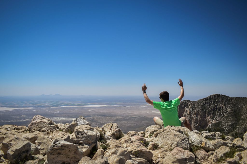 man on a hiking trail on top of a mountain